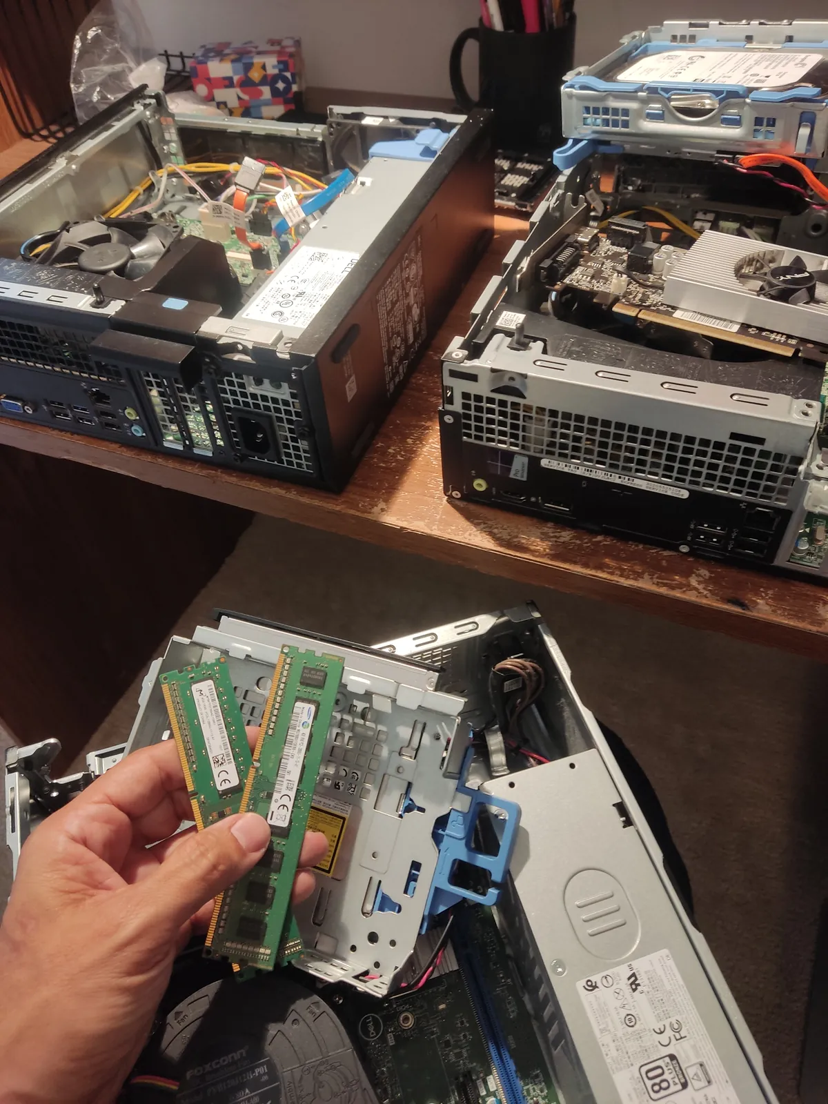 Hands assembling the radio station's computers piece by piece
